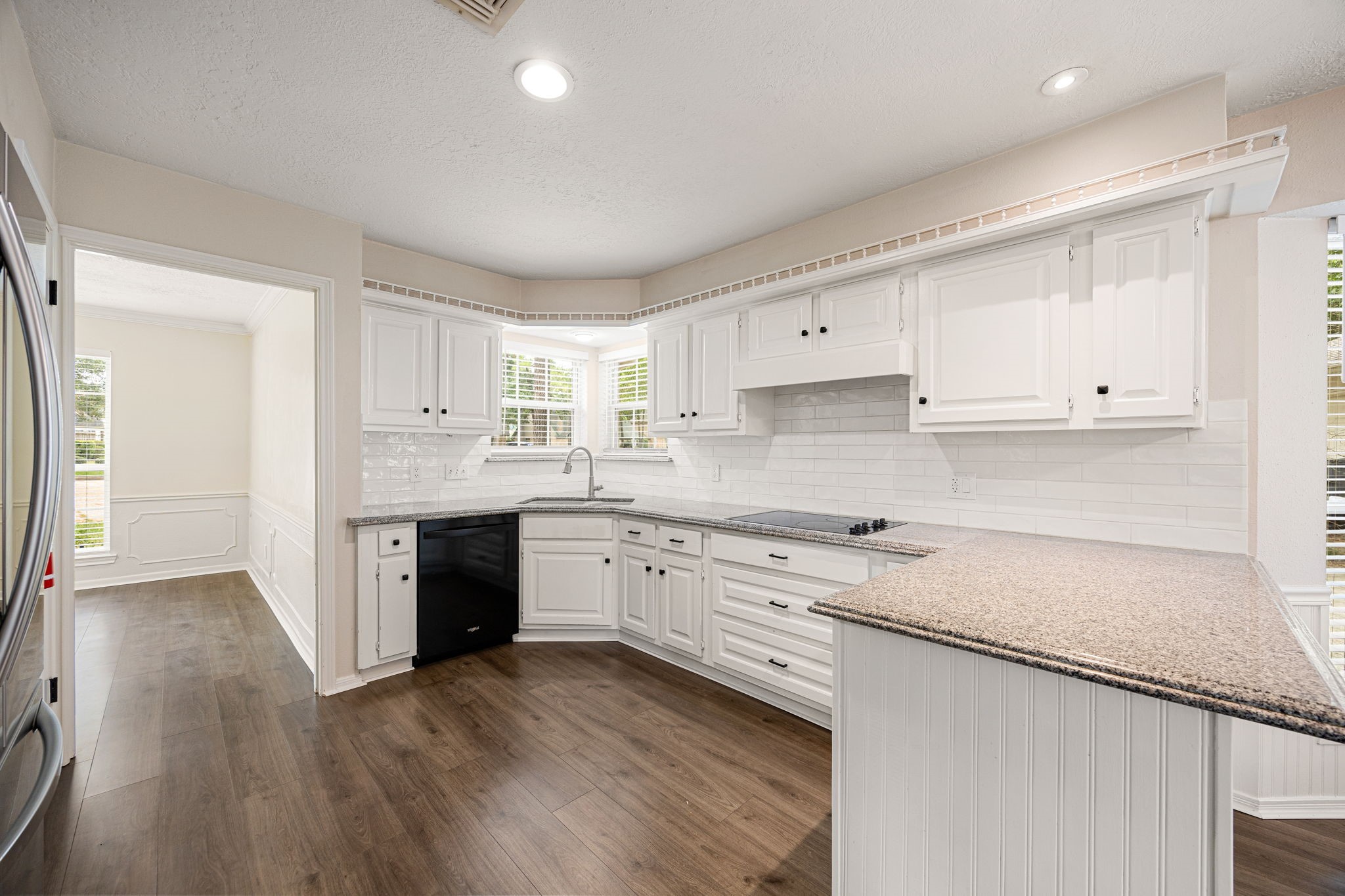 5527 Alamosa Lane Spring, TX 77379 - Photo 7 of 40 a kitchen with stainless steel appliances granite countertop a stove a sink and white cabinets