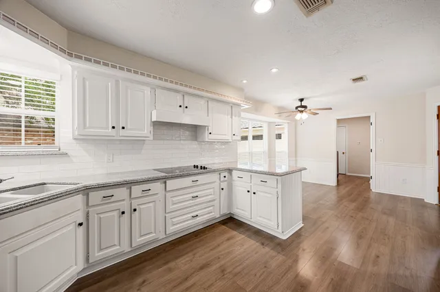 a view of a kitchen with a sink a refrigerator and window