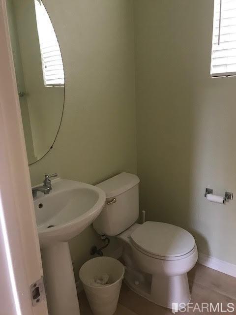 1228 Alder Creek Circle San Leandro, CA 94577 - Photo 3 of 9 a white toilet sitting next to a bathroom sink