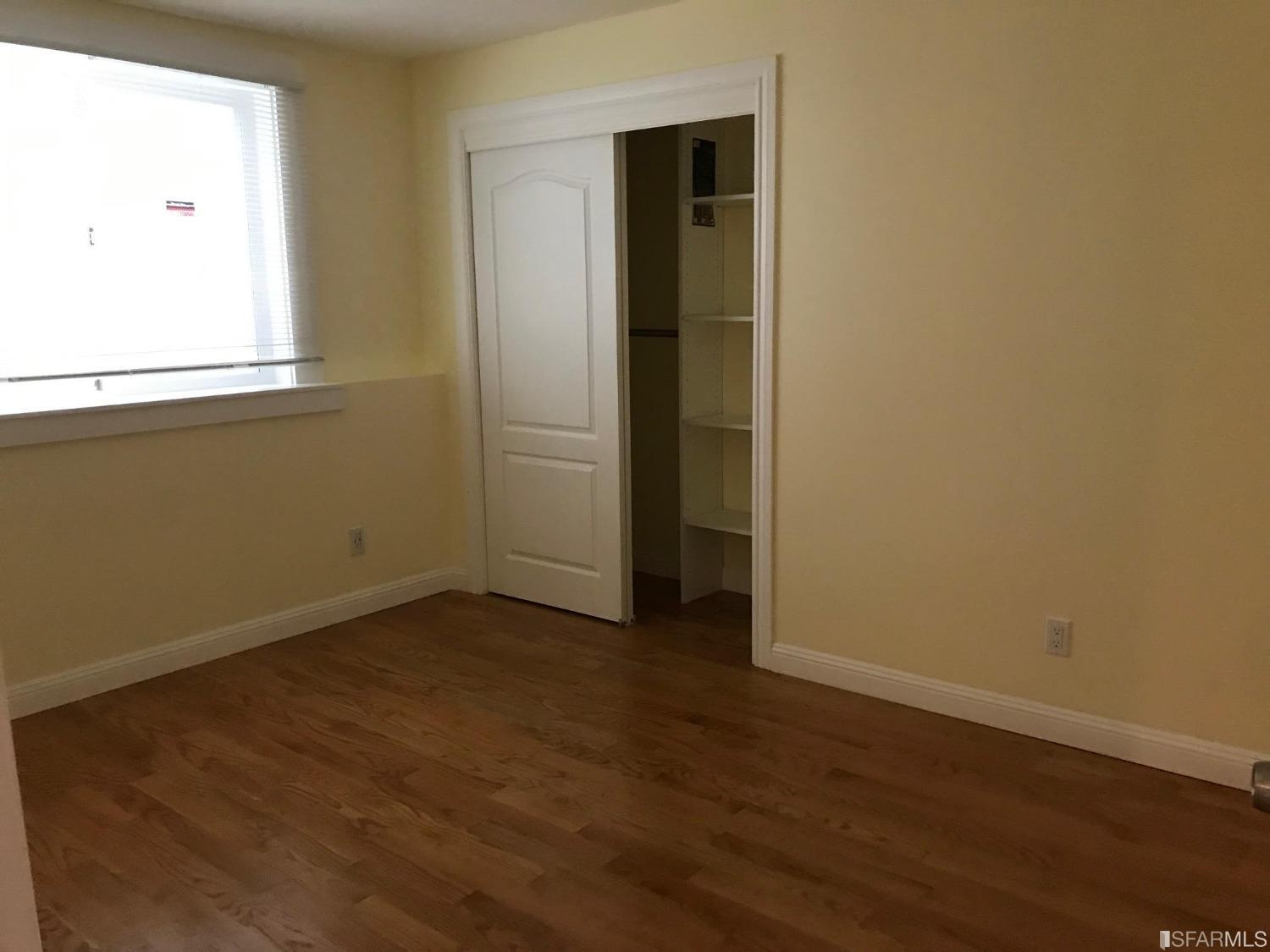 1228 Alder Creek Circle San Leandro, CA 94577 - Photo 4 of 9 an empty room with wooden floor and closet