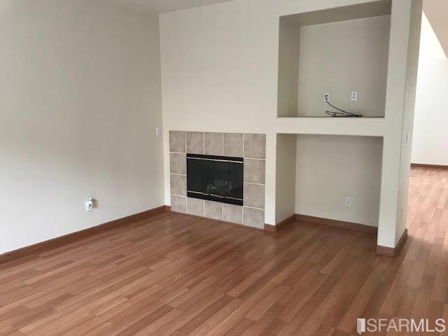 1228 Alder Creek Circle San Leandro, CA 94577 - Photo 6 of 9 a view of an empty room with wooden floor and a window