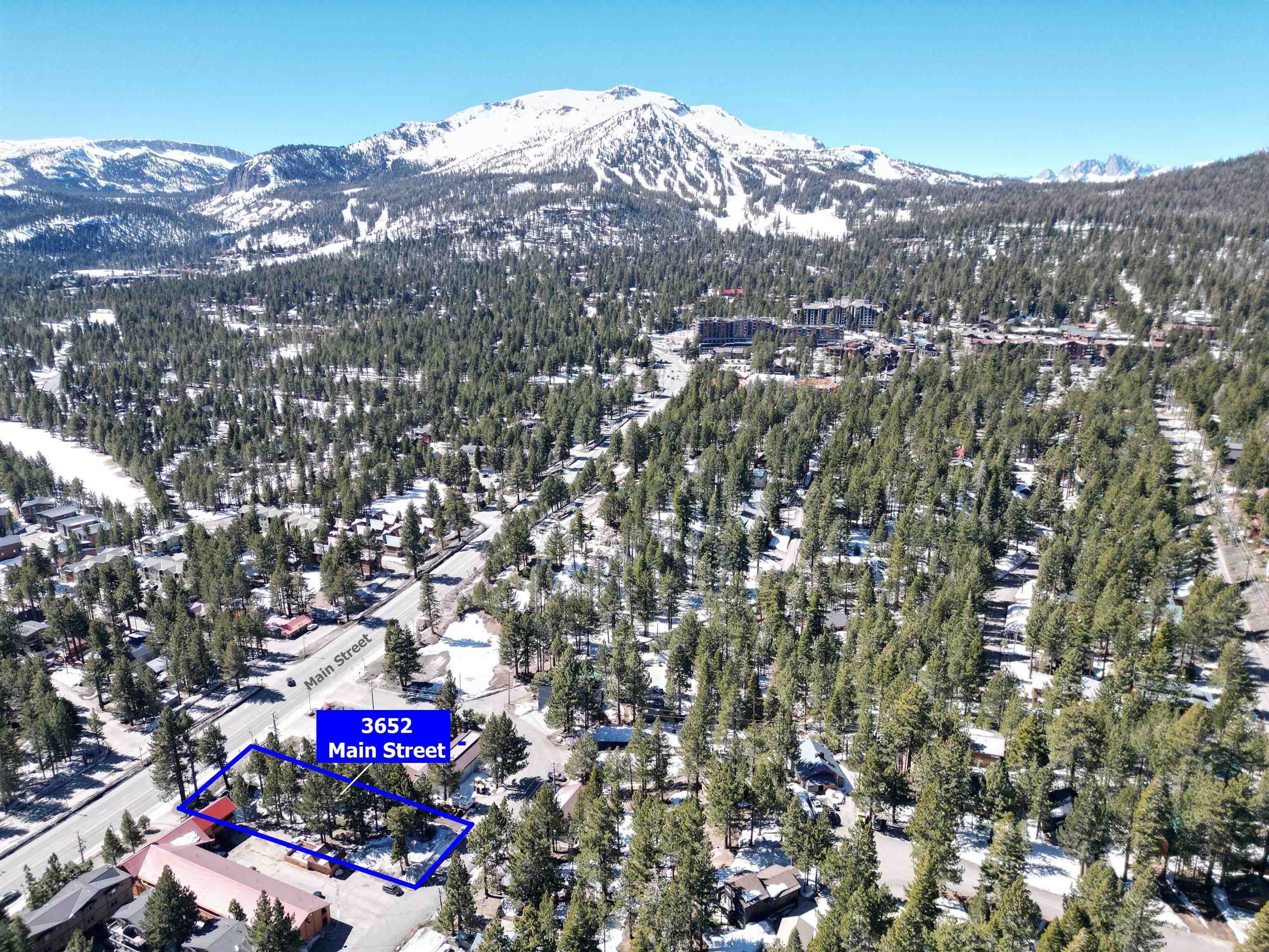 3652 Main Street Mammoth Lakes, CA 93546 - Photo 2 of 12 Aerial view of property and surrounding area featuring a mountainous background and property boundaries highlighted