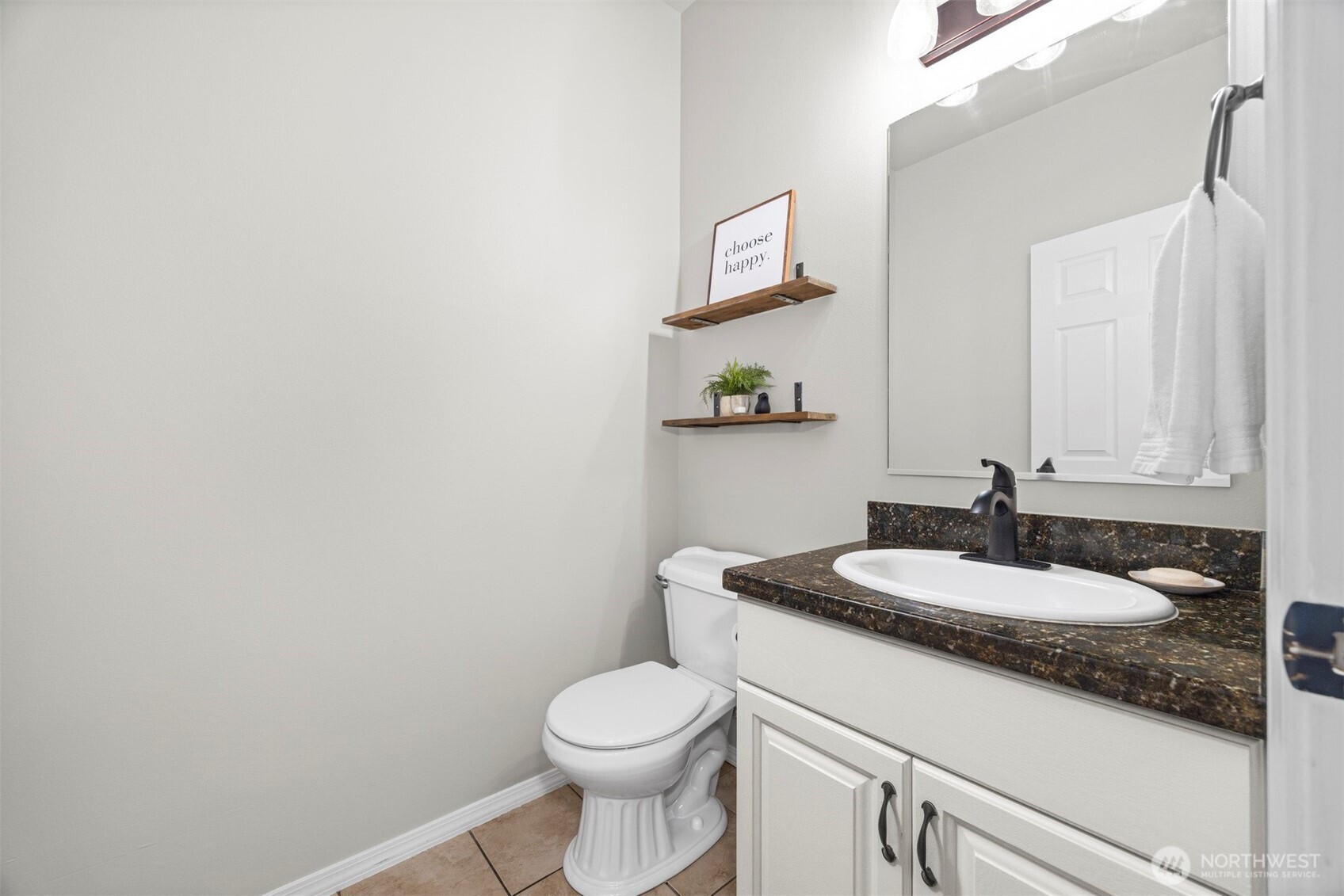 6729 Hawk Ridge Drive Ferndale, WA 98248 - Photo 23 of 40 a bathroom with a granite countertop toilet sink and mirror