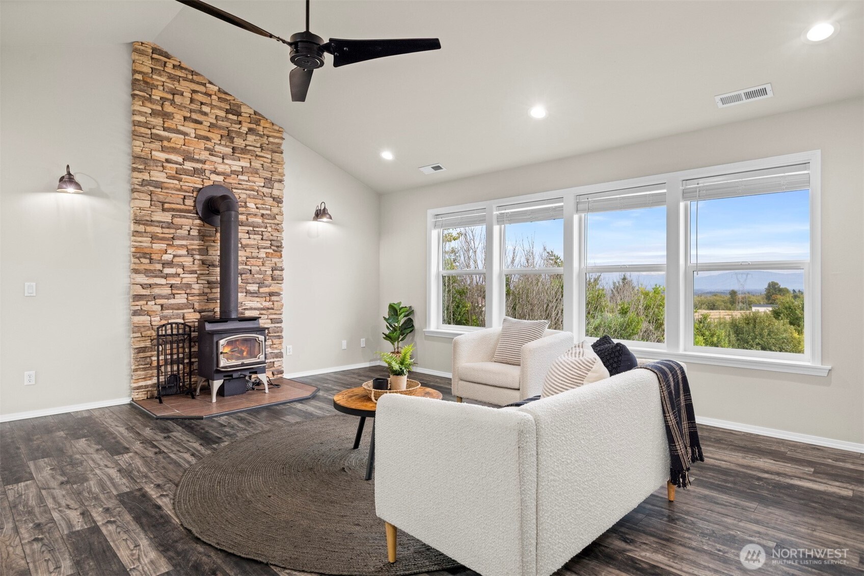 6729 Hawk Ridge Drive Ferndale, WA 98248 - Photo 25 of 40 a living room with furniture and floor to ceiling windows