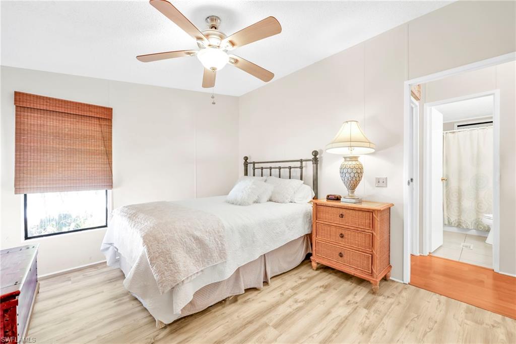 41 Oceans Boulevard, Unit 41 Naples, FL 34104 - Photo 12 of 32 a bedroom with a bed and a window