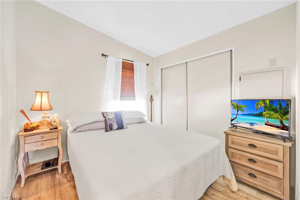 41 Oceans Boulevard, Unit 41 Naples, FL 34104 - Photo 16 of 32 a bedroom with a bed and a flat screen tv