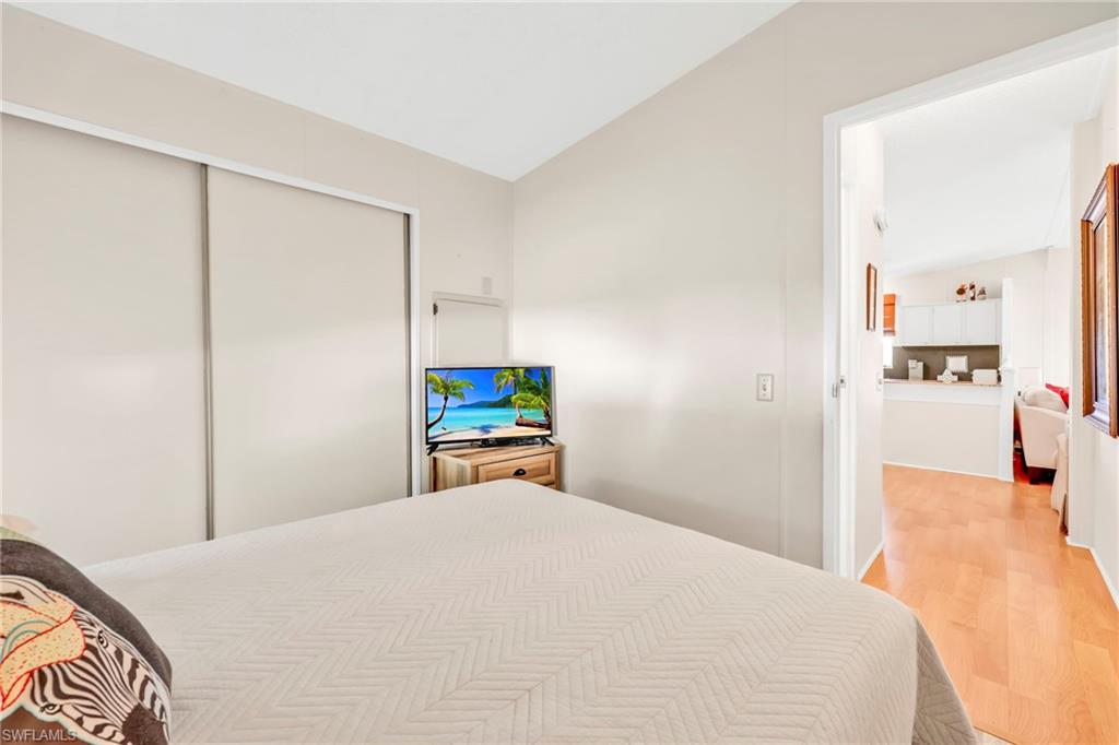 41 Oceans Boulevard, Unit 41 Naples, FL 34104 - Photo 17 of 32 a bedroom with a bed and a table in it