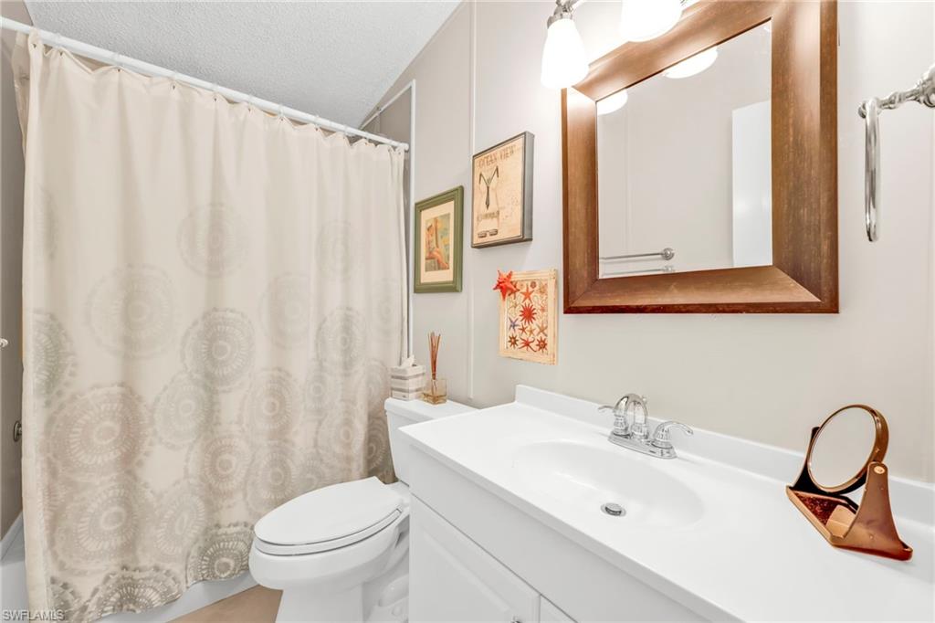 41 Oceans Boulevard, Unit 41 Naples, FL 34104 - Photo 18 of 32 a bathroom with a sink toilet and mirror