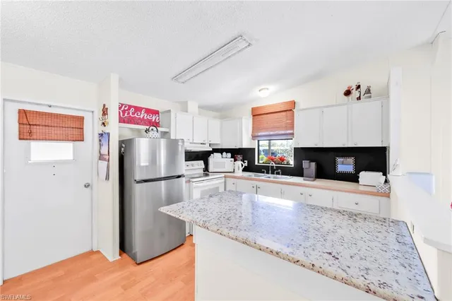 a living room with kitchen island furniture and a kitchen view