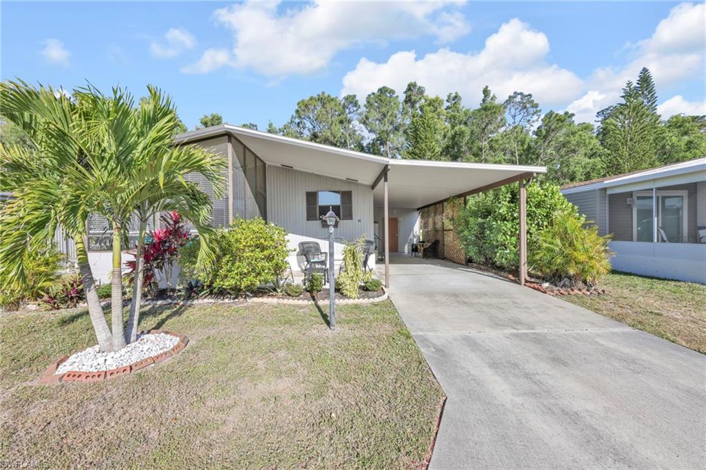 41 Oceans Boulevard, Unit 41 Naples, FL 34104 - Photo 19 of 32 a view of a backyard with plants and a patio