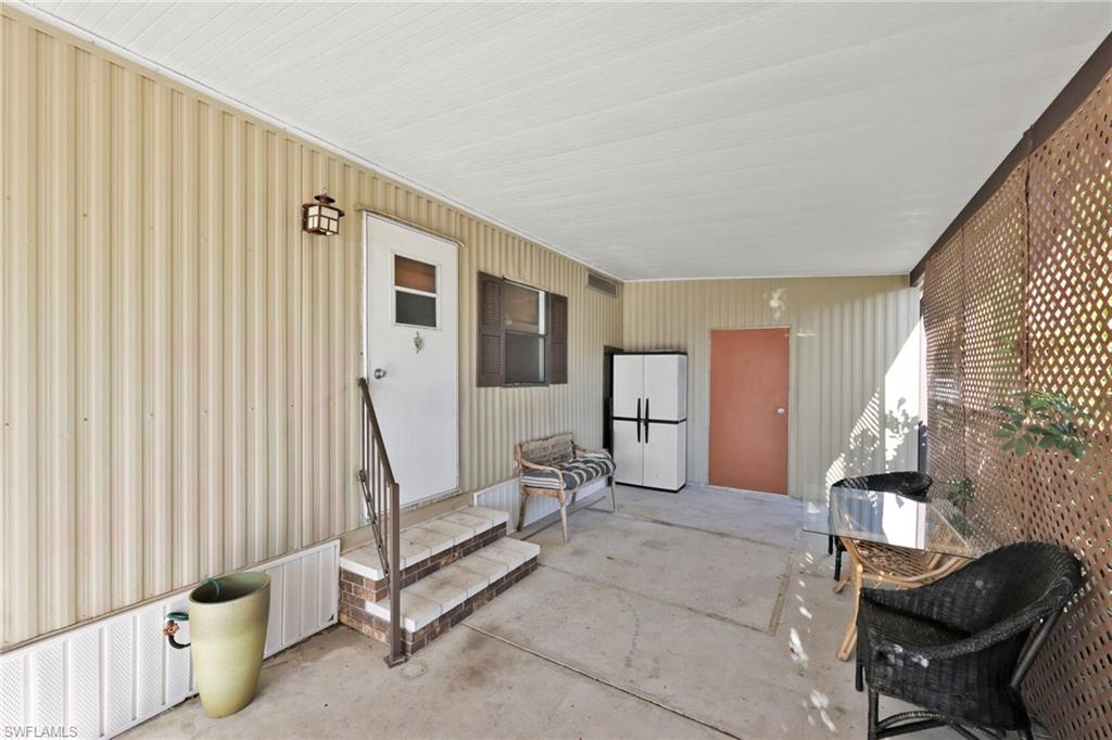 41 Oceans Boulevard, Unit 41 Naples, FL 34104 - Photo 21 of 32 a view of a livingroom with furniture and windows