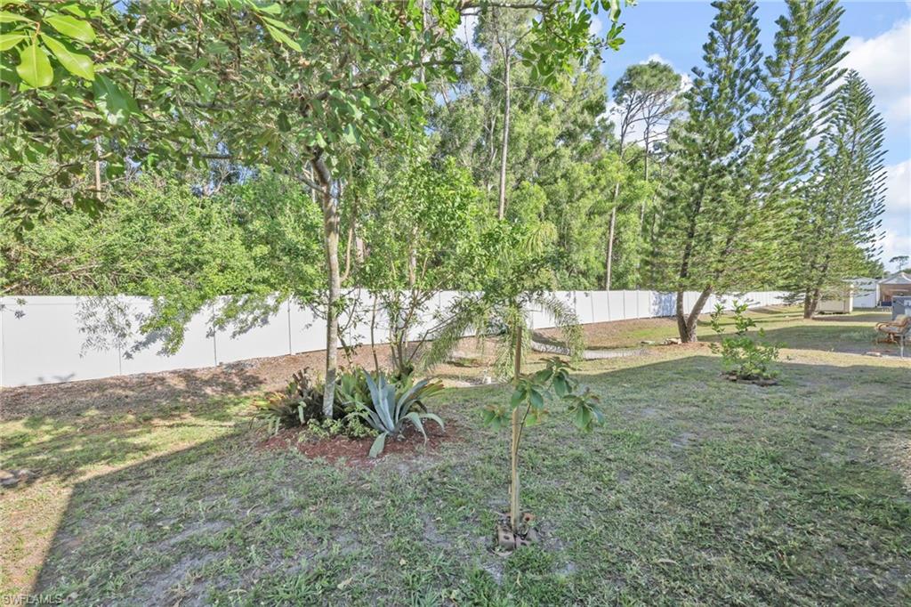 41 Oceans Boulevard, Unit 41 Naples, FL 34104 - Photo 22 of 32 a backyard of a house with table and chairs