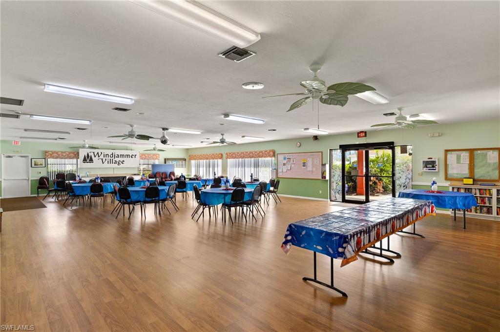 41 Oceans Boulevard, Unit 41 Naples, FL 34104 - Photo 24 of 32 a room with lots of furniture and wooden floors