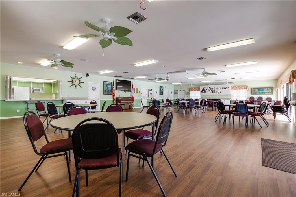 41 Oceans Boulevard, Unit 41 Naples, FL 34104 - Photo 25 of 32 a dining room with lots of furniture wooden floor and a rug