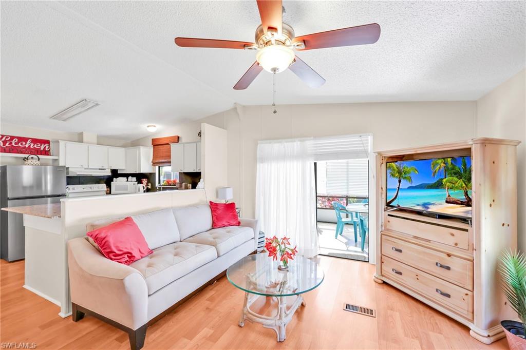 41 Oceans Boulevard, Unit 41 Naples, FL 34104 - Photo 8 of 32 a living room with furniture and kitchen view