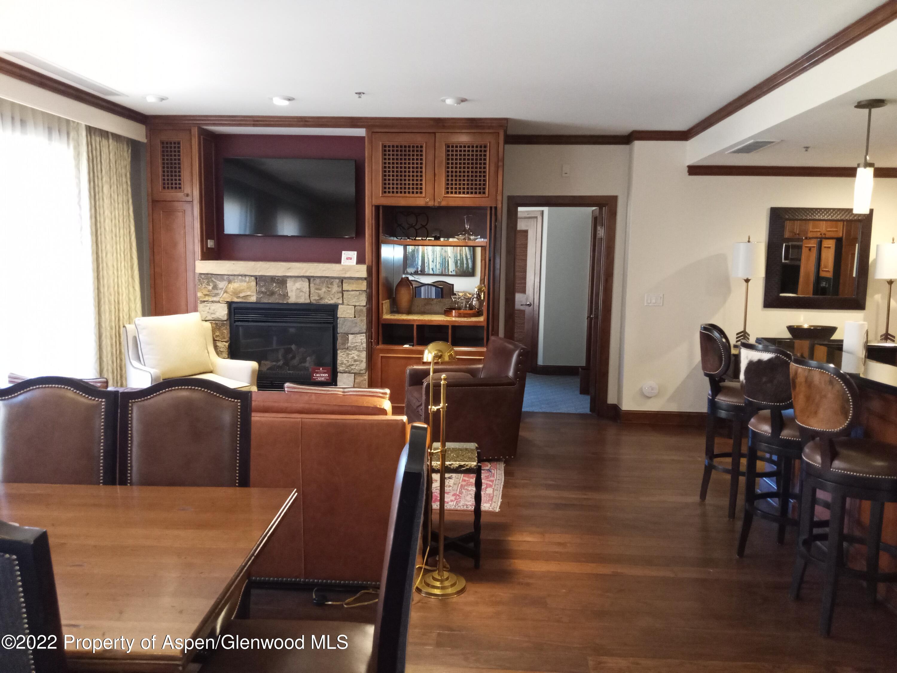 39 Boomerang Road, Unit 8216 SUMMER INTEREST 8 Aspen, CO 81611 - Photo 7 of 27 a living room with furniture a flat screen tv and a fireplace