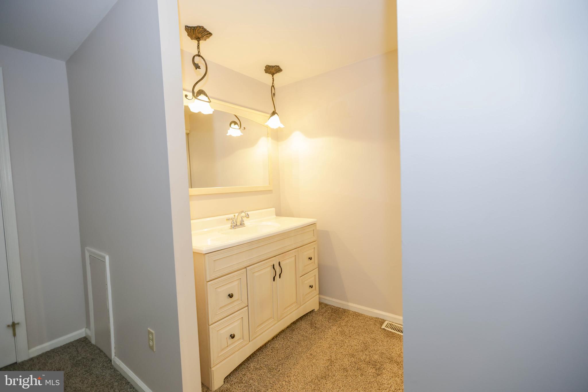 742 Summit Chase Drive Reading, PA 19611 - Photo 13 of 20 a bathroom with a granite countertop sink and a mirror