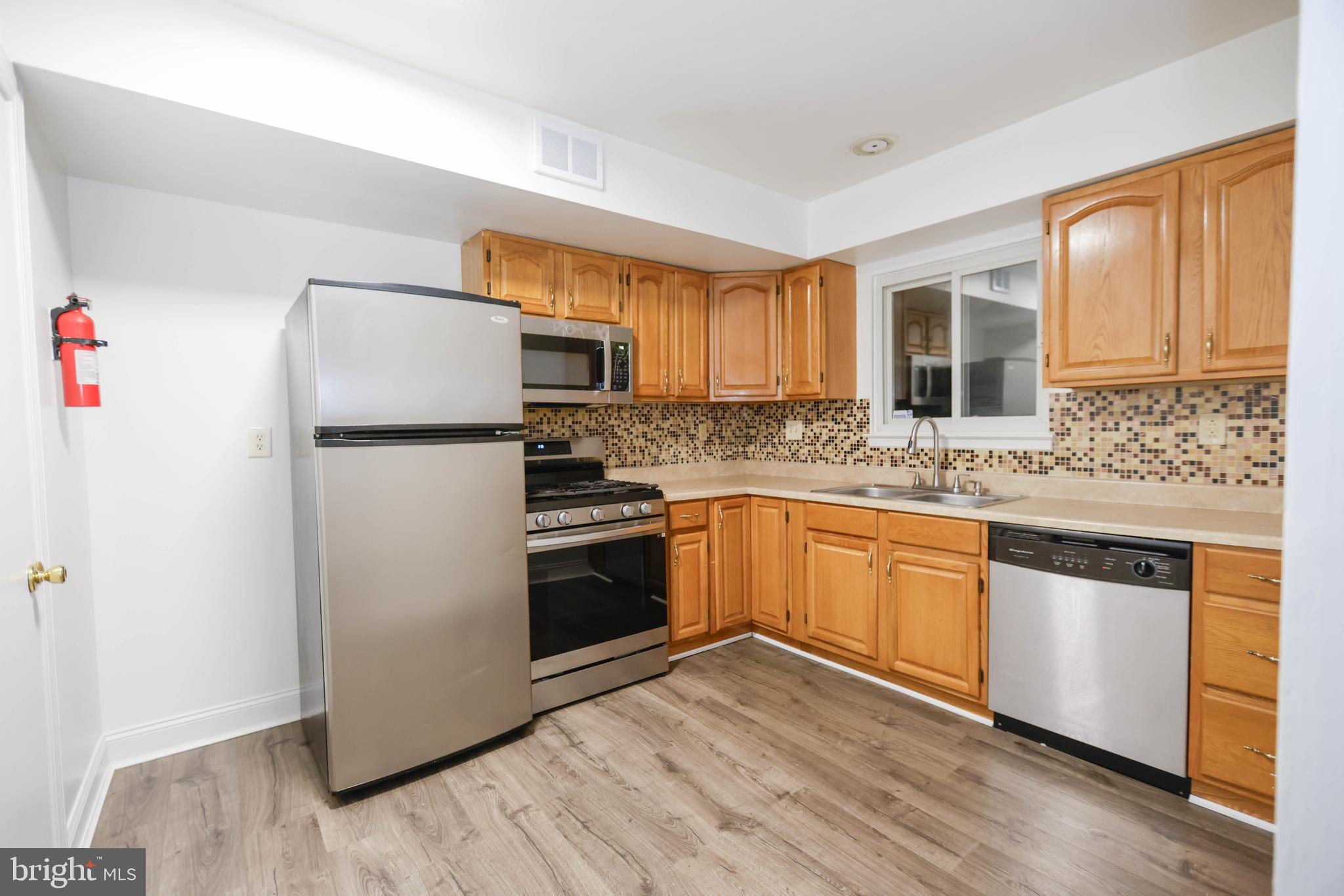742 Summit Chase Drive Reading, PA 19611 - Photo 4 of 20 a kitchen with a refrigerator cabinets and wooden floor