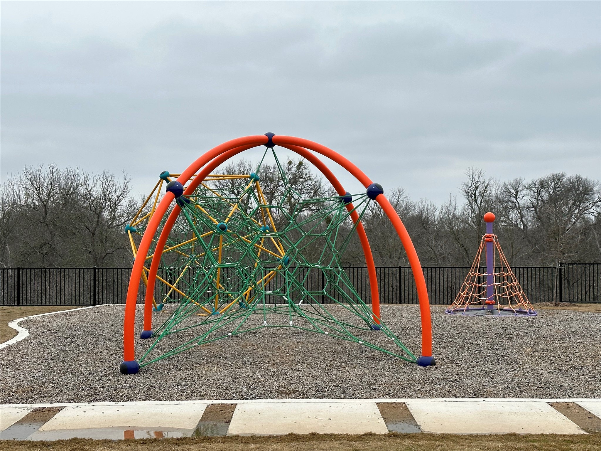 13501 Mussel Run Elgin, TX 78621 - Photo 21 of 28 Recreational area featuring a large climbing structure with orange arches and green rope netting