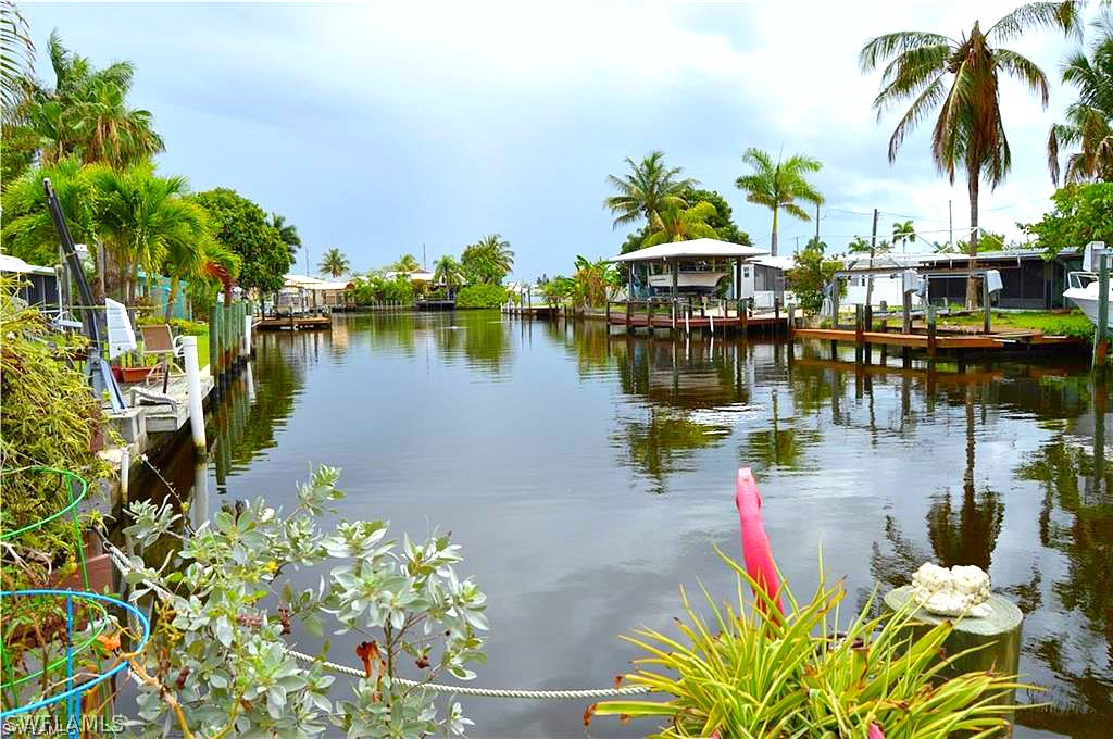 a swimming pool with outdoor seating and plants