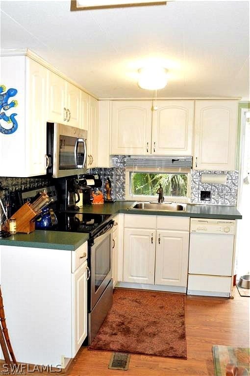2591 Cay Cove Matlacha, FL 33993 - Photo 13 of 20 a kitchen with stainless steel appliances granite countertop a stove a sink and a microwave