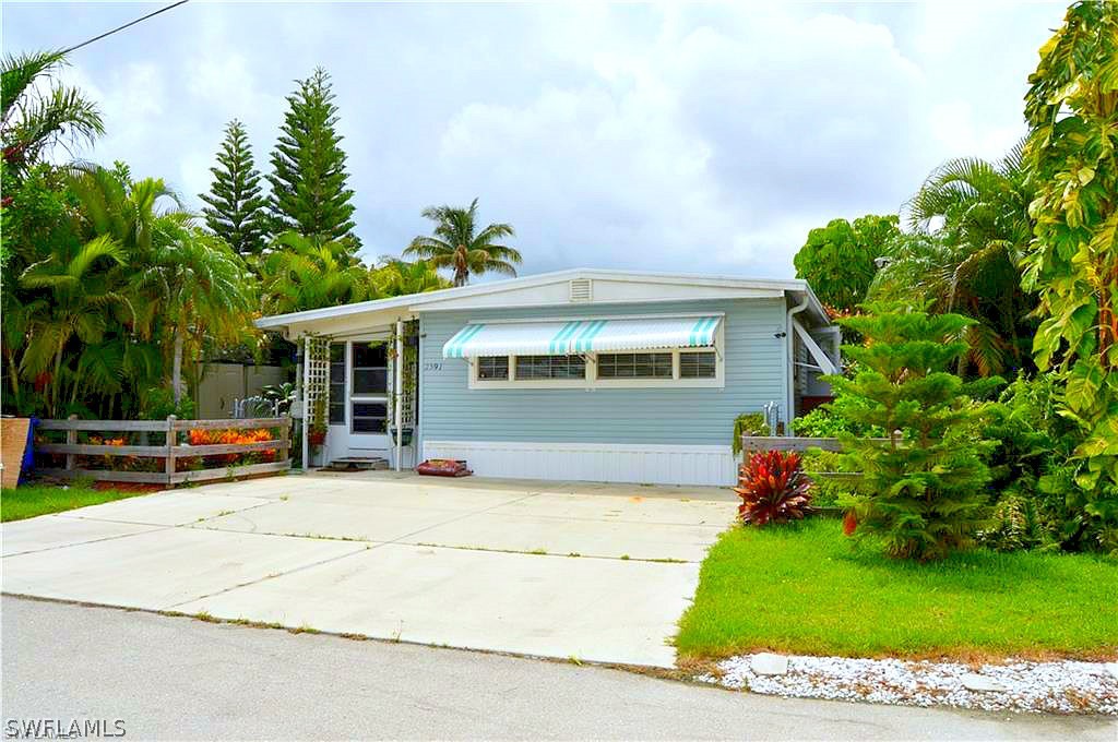 2591 Cay Cove Matlacha, FL 33993 - Photo 2 of 20 a view of a house with a yard and sitting area