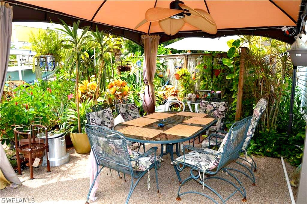 2591 Cay Cove Matlacha, FL 33993 - Photo 6 of 20 a patio with table and chairs and potted plants