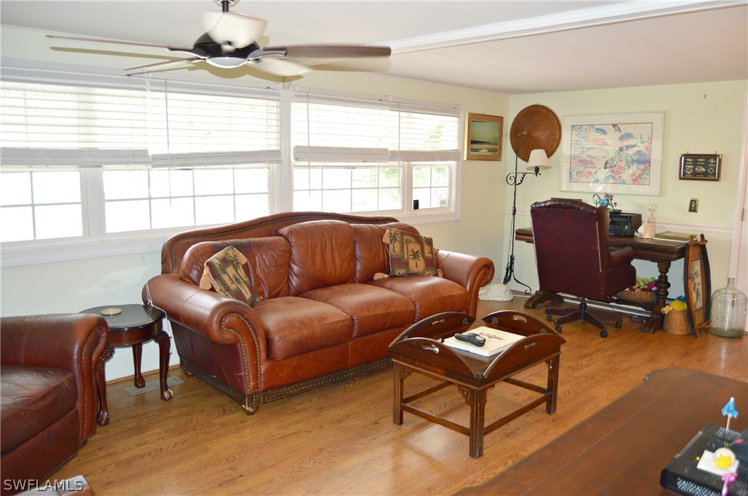 2591 Cay Cove Matlacha, FL 33993 - Photo 10 of 20 a living room with furniture a fireplace and a large window
