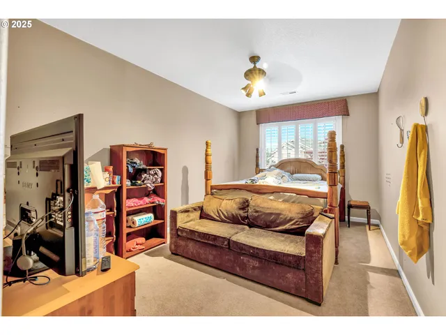 a bedroom with a bed closet and a window