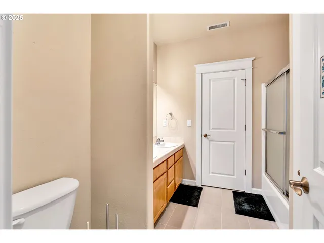 a bathroom with a sink a toilet a vanity and mirror
