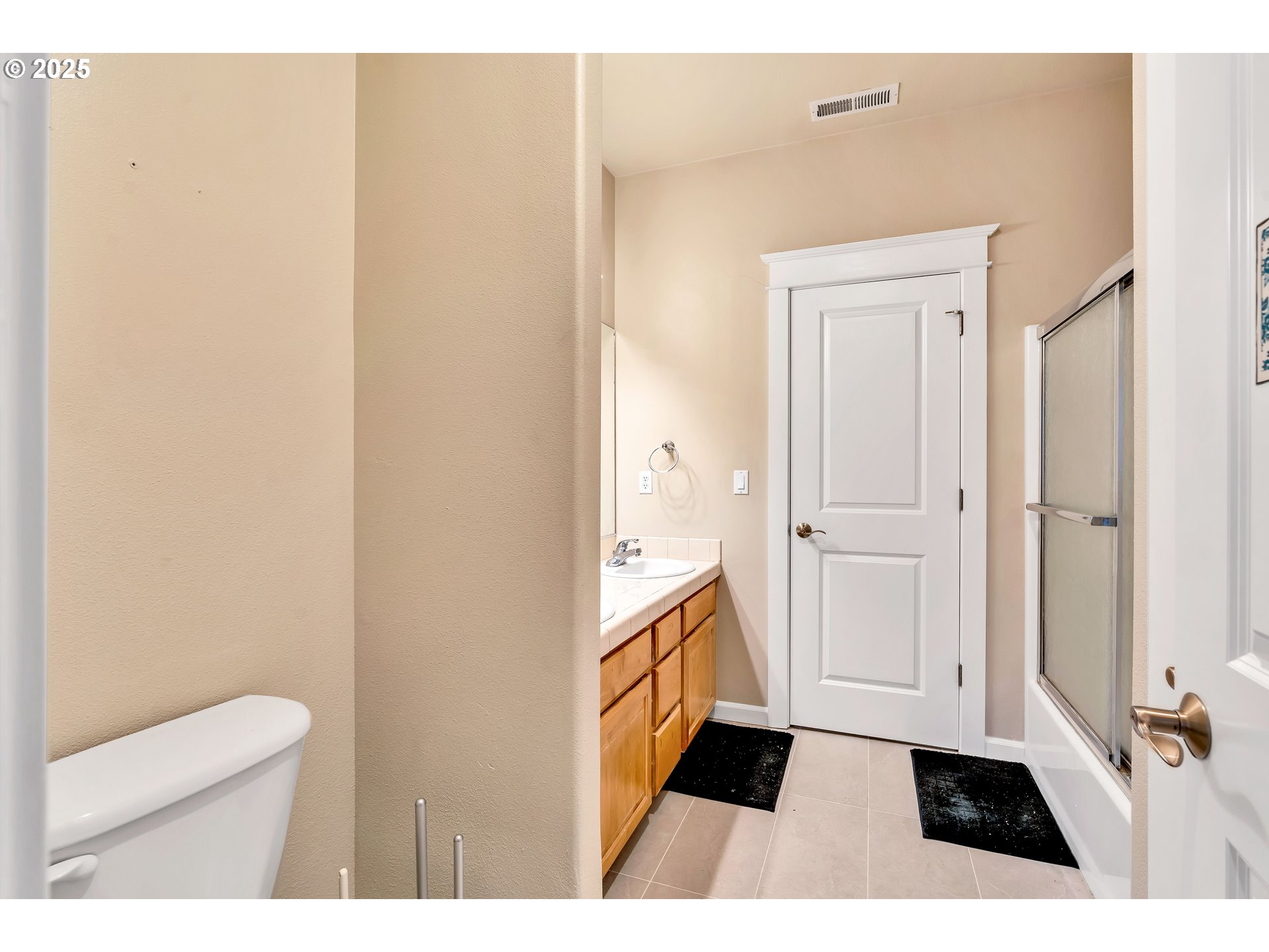 13755 Southwest Sandridge Drive Portland, OR 97223 - Photo 16 of 36 a bathroom with a sink a toilet a vanity and mirror