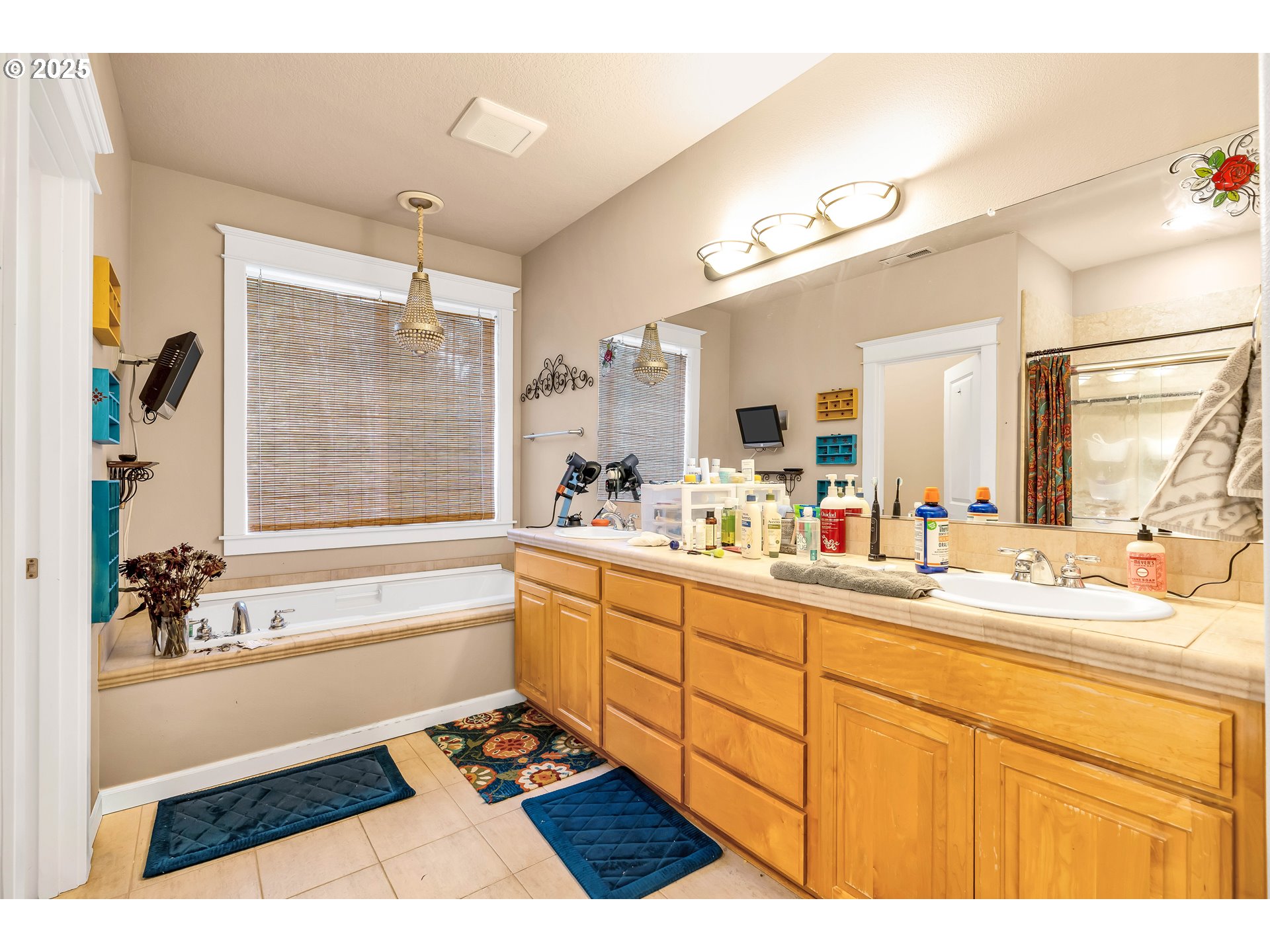 13755 Southwest Sandridge Drive Portland, OR 97223 - Photo 19 of 36 a bathroom with a sink double vanity granite tub shower and a mirror