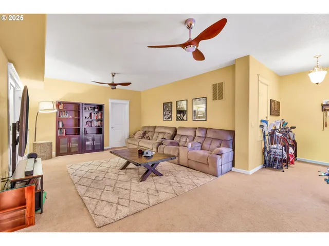 a living room with furniture gym equipment and a flat screen tv