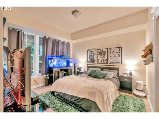 a bedroom with a bed window and mirror