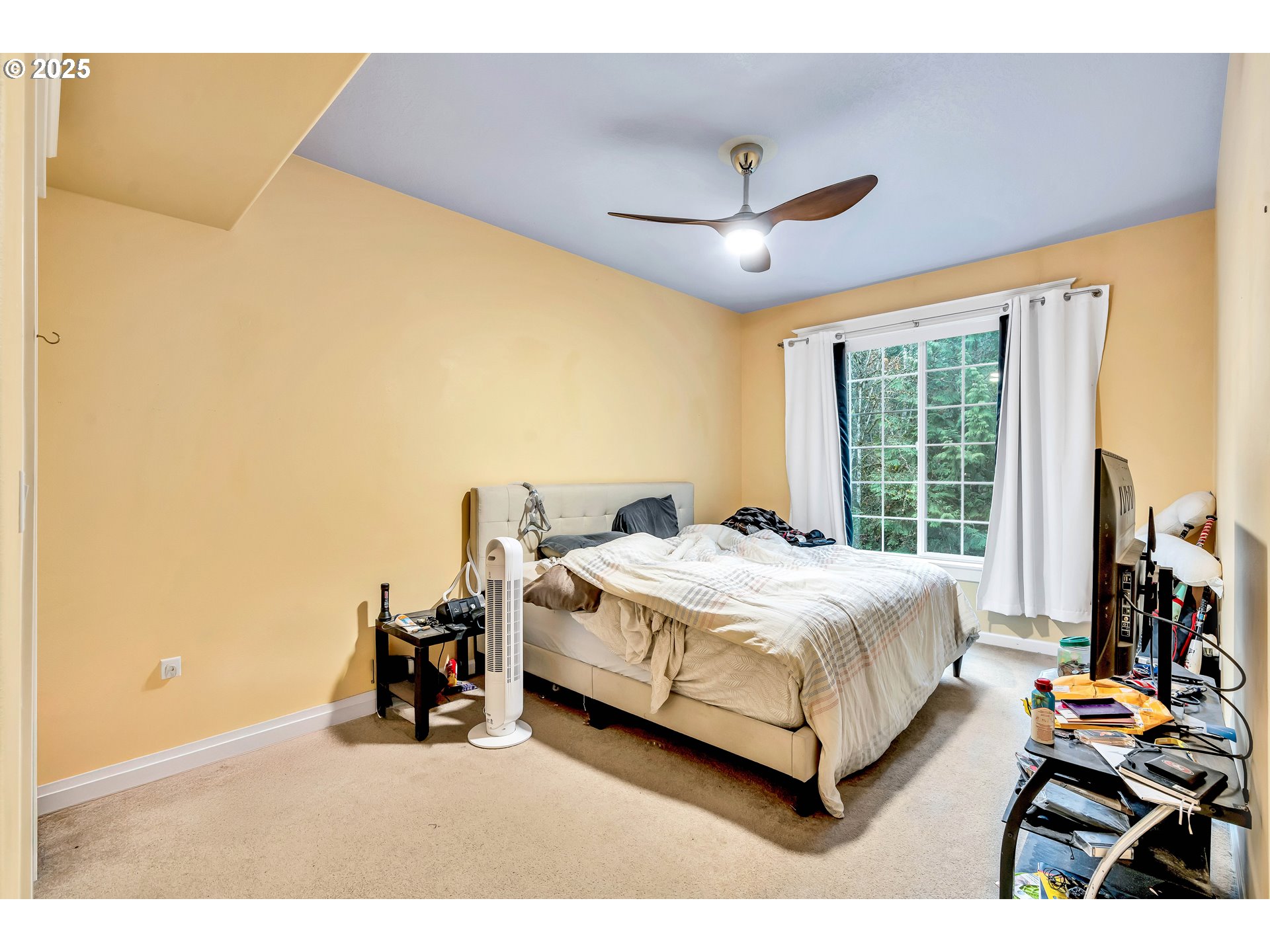 13755 Southwest Sandridge Drive Portland, OR 97223 - Photo 26 of 36 a bed room with a bed and a chair