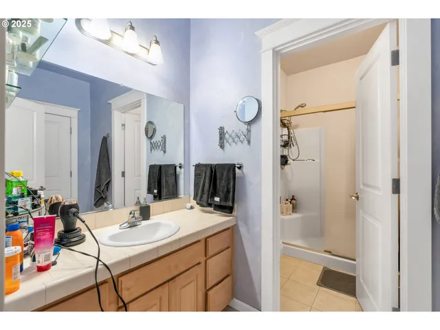 a bathroom with a sink vanity and a mirror