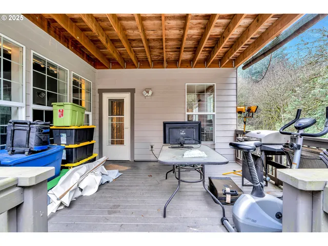 a living room with furniture a flat screen tv and a table