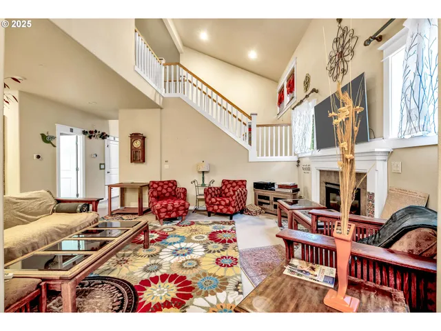 a living room with patio furniture and a rug