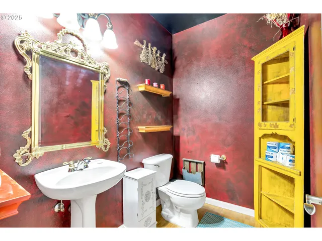 a bathroom with a sink a toilet and mirror