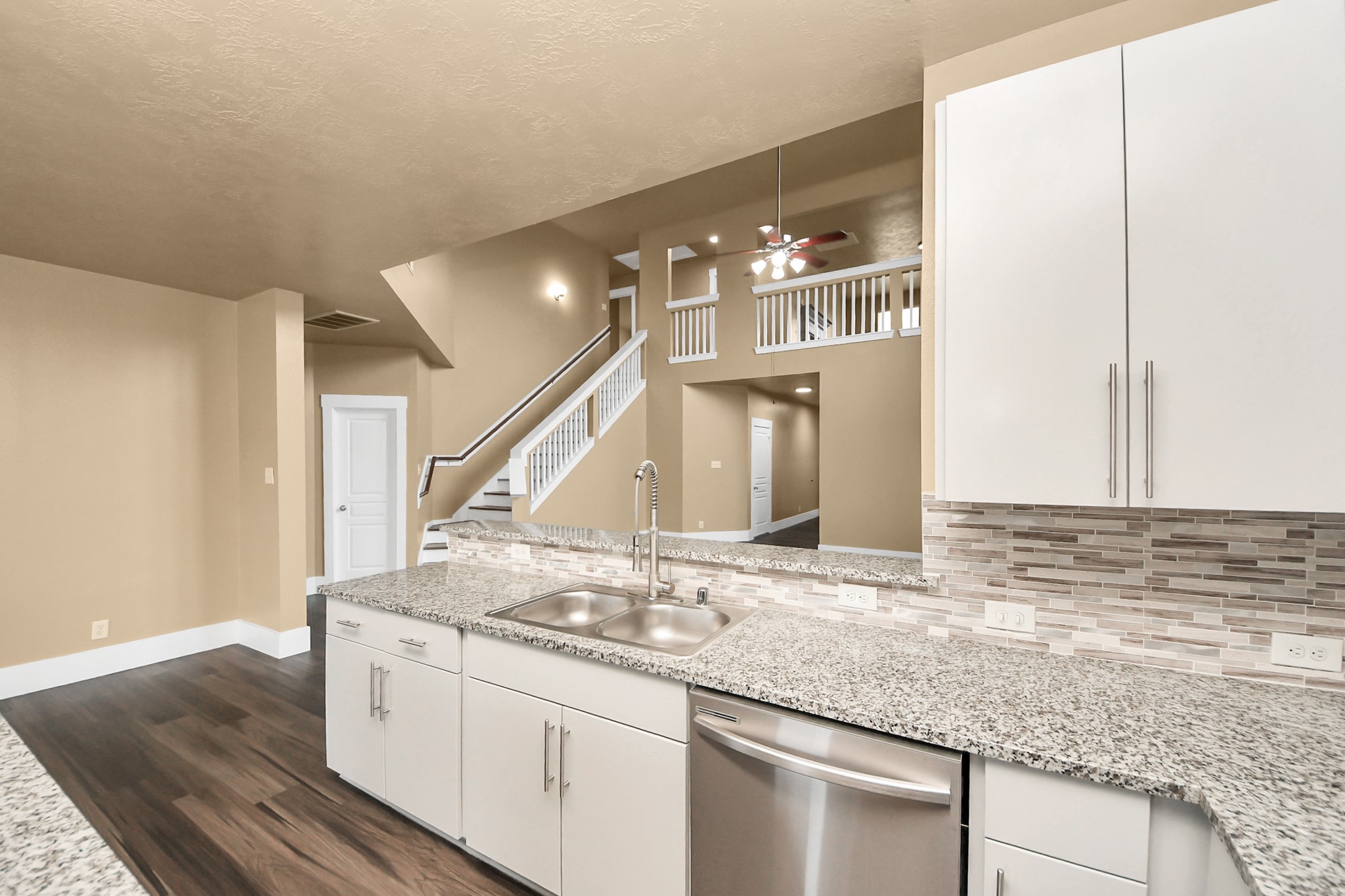 1 Desert Spring Lane Manvel, TX 77578 - Photo 14 of 45 a kitchen with granite countertop a sink and a white wooden cabinets