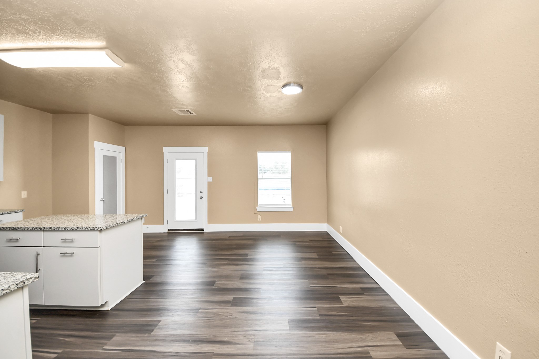 1 Desert Spring Lane Manvel, TX 77578 - Photo 17 of 45 a view of an empty room with wooden floor and a window