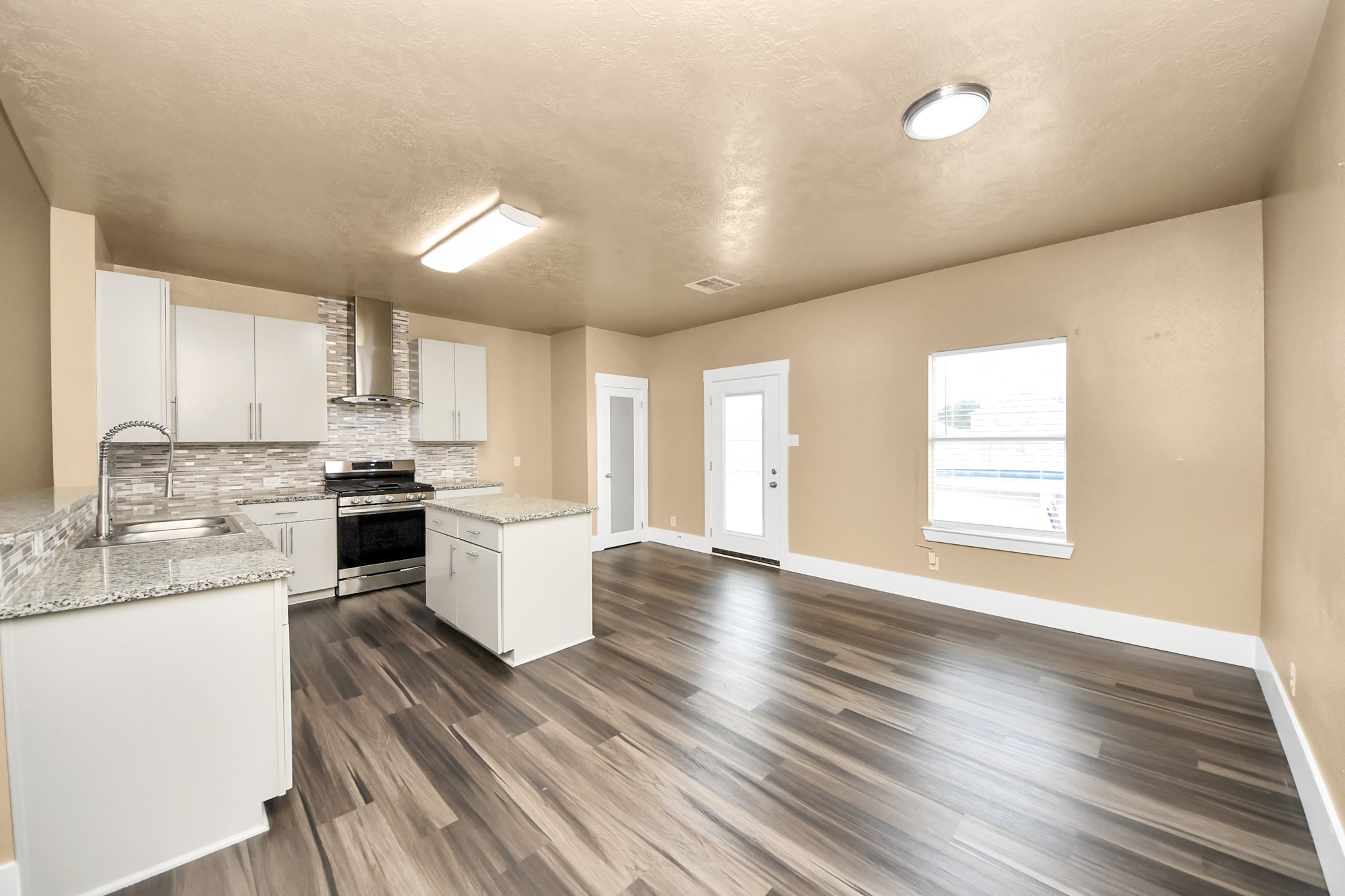 1 Desert Spring Lane Manvel, TX 77578 - Photo 18 of 45 a kitchen with a sink wooden floor stainless steel appliances and cabinets