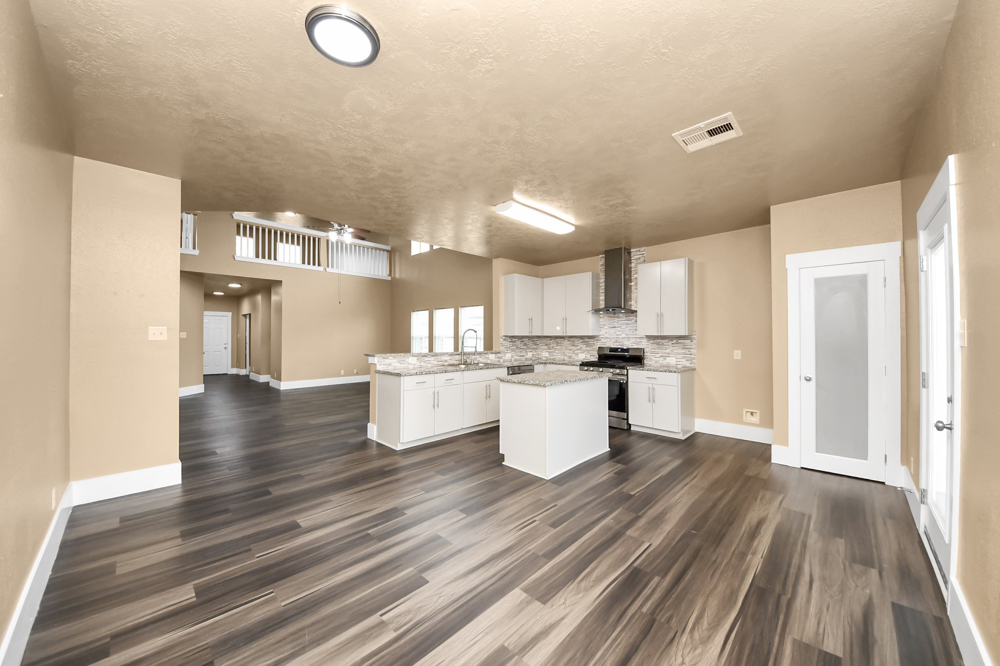 1 Desert Spring Lane Manvel, TX 77578 - Photo 19 of 45 a open kitchen with white cabinets and stainless steel appliances