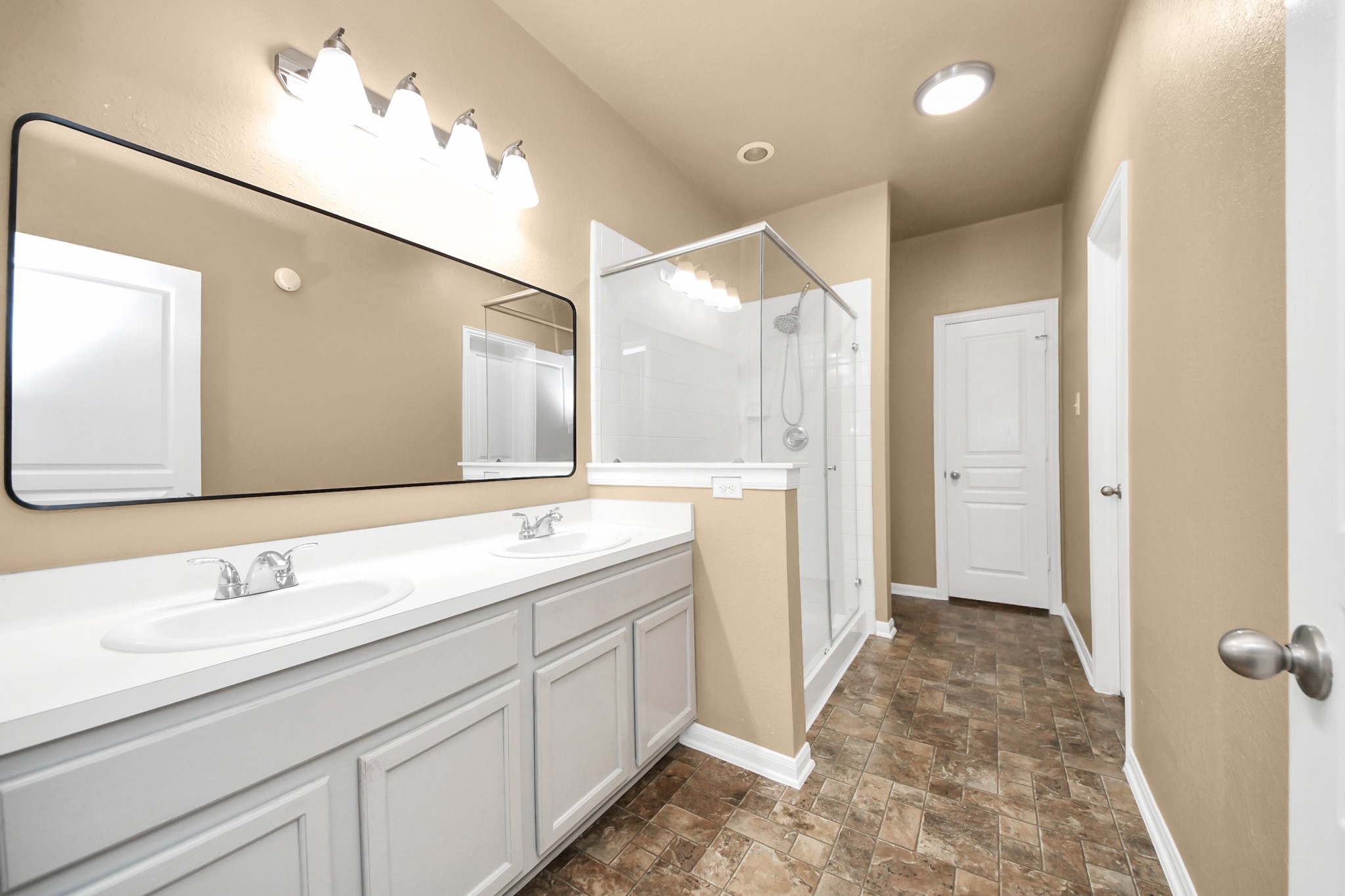 1 Desert Spring Lane Manvel, TX 77578 - Photo 24 of 45 a spacious bathroom with a shower sink and mirror