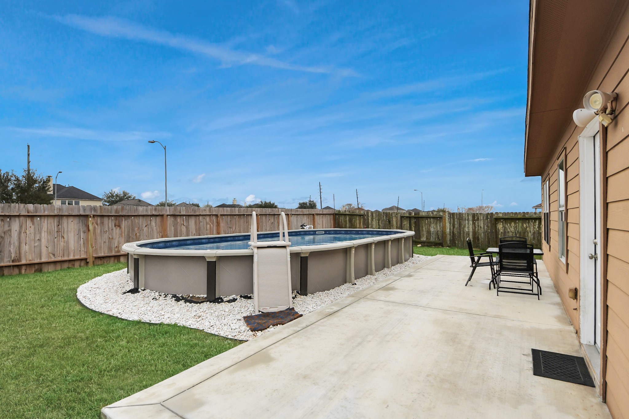 1 Desert Spring Lane Manvel, TX 77578 - Photo 39 of 45 a view of a patio with chairs a table and chairs with wooden fence
