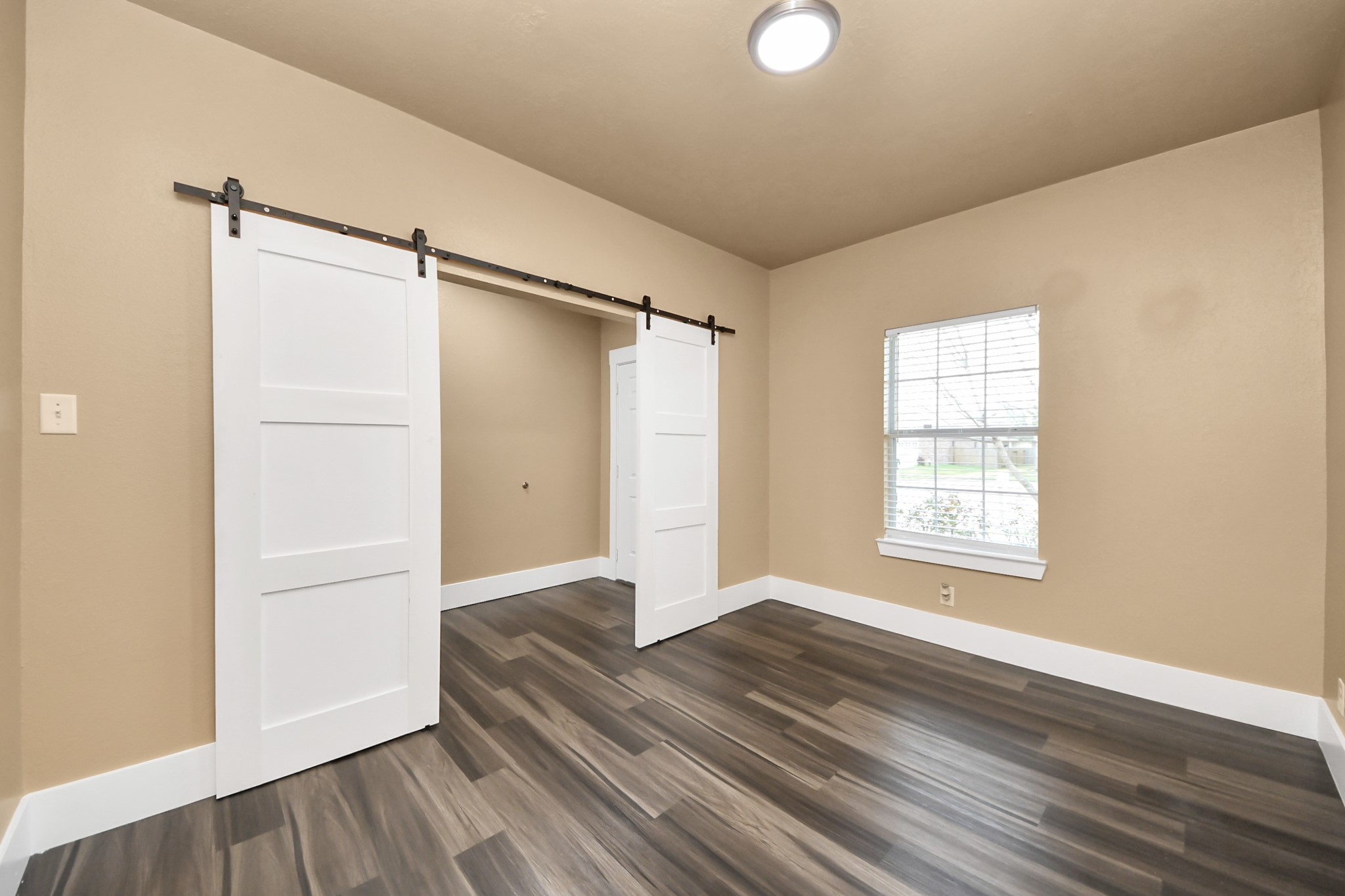 1 Desert Spring Lane Manvel, TX 77578 - Photo 5 of 45 a view of an empty room with wooden floor and a window