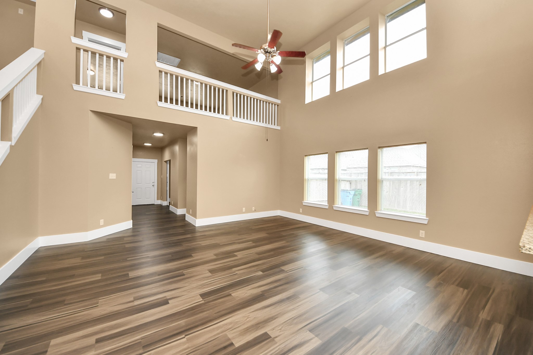 1 Desert Spring Lane Manvel, TX 77578 - Photo 7 of 45 a view of an empty room with wooden floor and a window