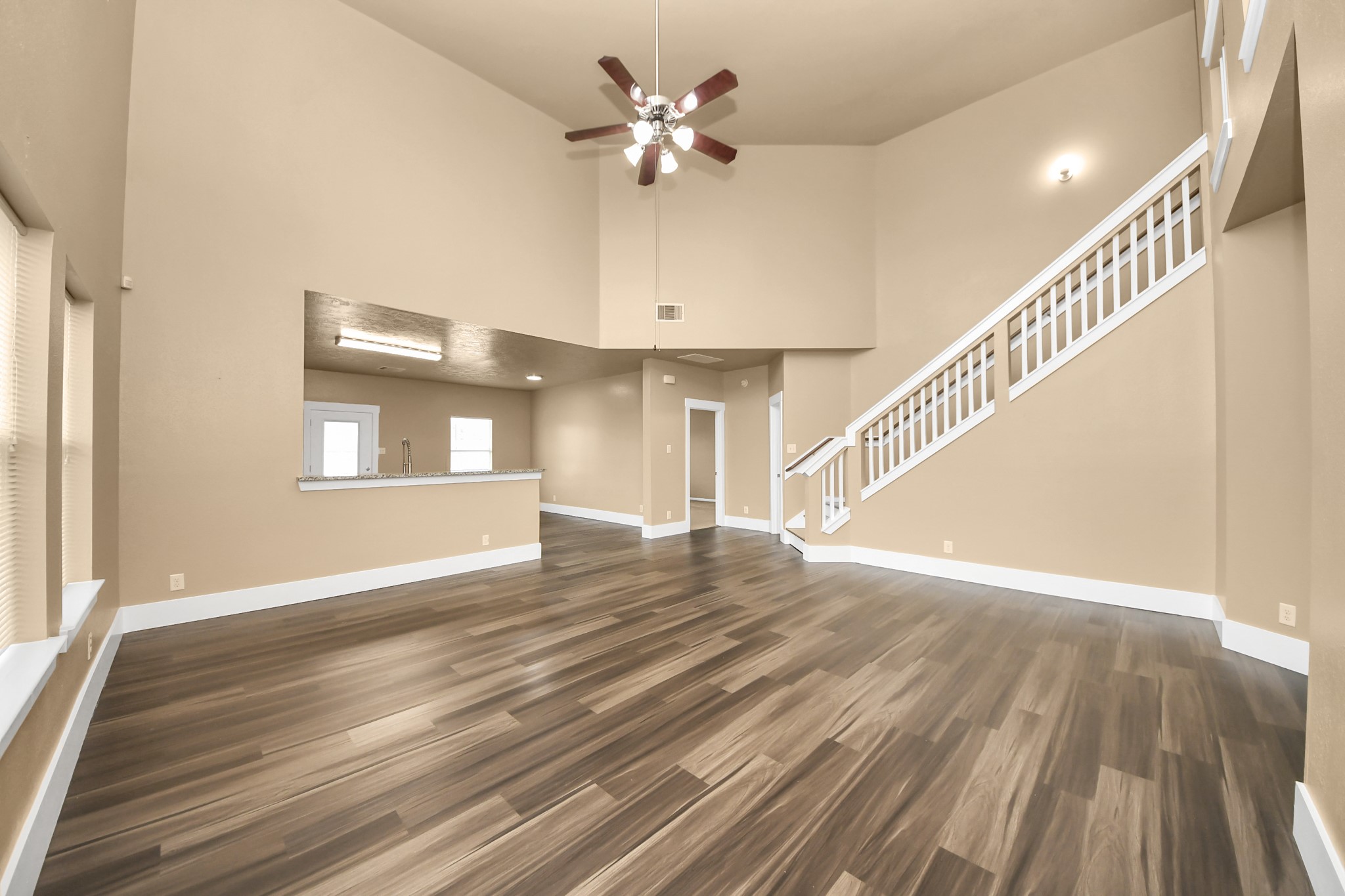 1 Desert Spring Lane Manvel, TX 77578 - Photo 8 of 45 a view of an empty room with wooden floor and a chandelier fan