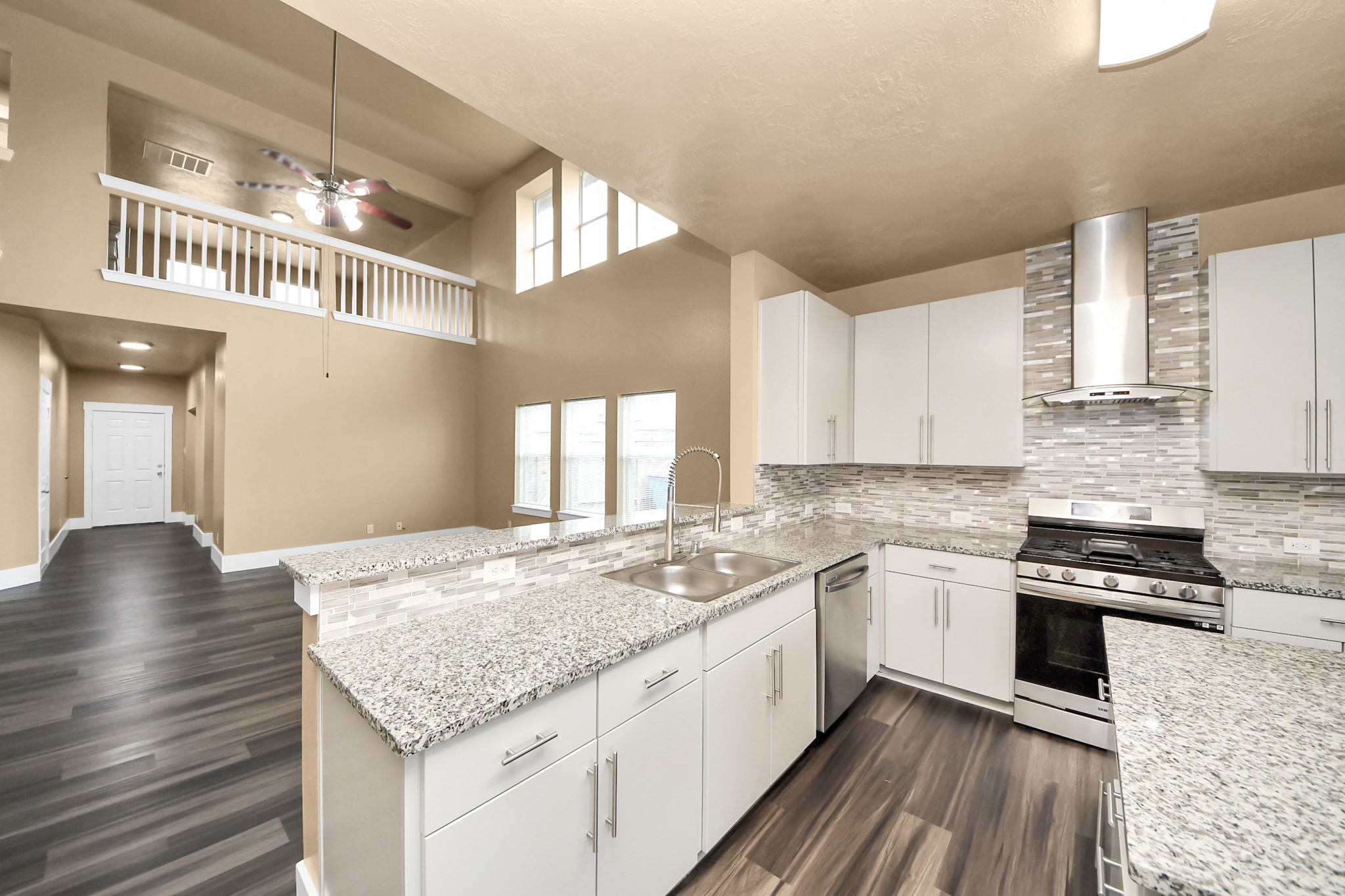 1 Desert Spring Lane Manvel, TX 77578 - Photo 10 of 45 a kitchen with stainless steel appliances granite countertop a sink stove and cabinets