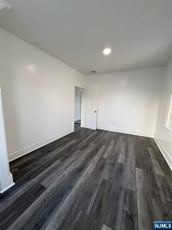a view of an empty room and wooden floor